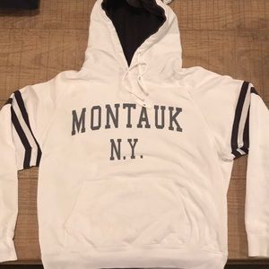 White hoodie sweatshirt with”montauk NY.” on chest
